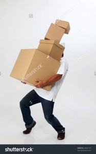 stock-photo-a-man-struggling-to-carry-moving-boxes-38281774